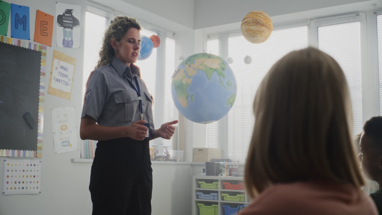 Children Sitting Listening to Police Worker Guidance About Knowledge of Law and Responsibility