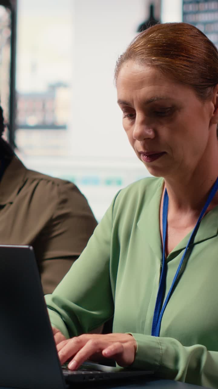Vertical Video Ambitious focused woman at desk reviewing business strategy