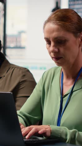 vertical video ambitious focused woman at desk reviewing business strategy