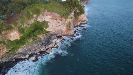 Waves-Crashing-on-Yogyakarta-Island-Sea-Cliffs-on-Bali-Ocean-Coastline,-Aerial