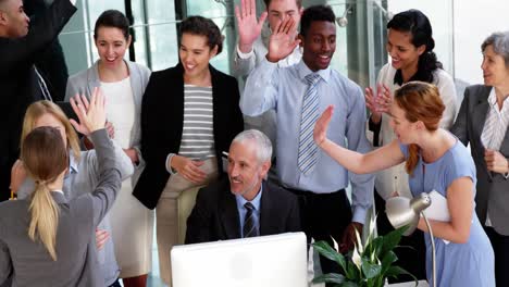 business people giving a high five to each other