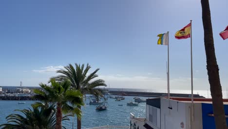 Banderas-De-Canarias-Y-España-Ondeando-Junto-Al-Puerto-De-Arguineguin.