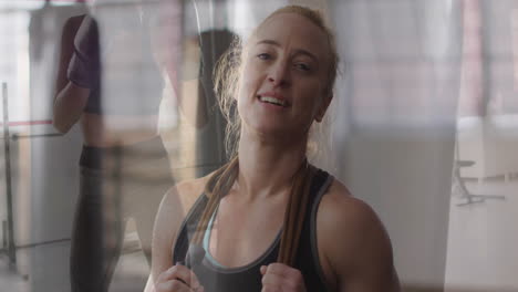 holding jump rope, woman smiling confidently in fitness studio animation class