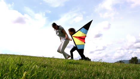 woman and her daughter running with kite