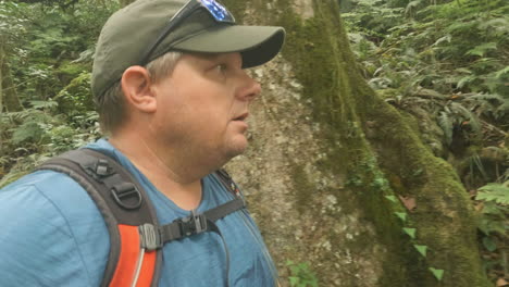 4K-wide-angle-side-view-of-a-man-walking-a-hiking-trail-in-a-tropical-mountain-rainforest,-Mount-Cordeaux,-Main-Range-National-Park-Qld