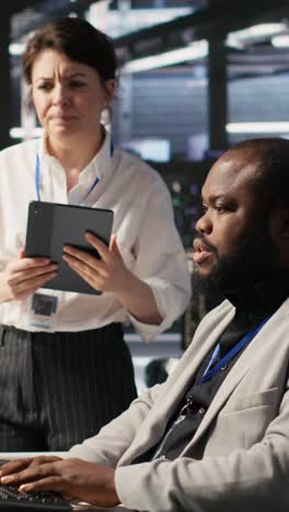 vertical video server room manager supervising technician examining deep learning algorithms