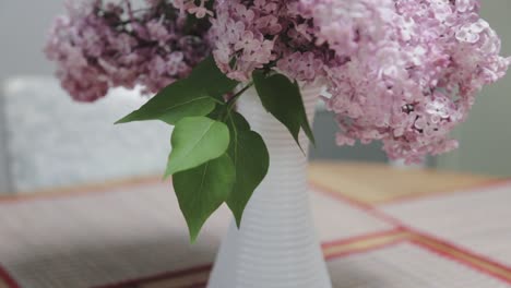 close up panning shot of lilacs on a kitchen table