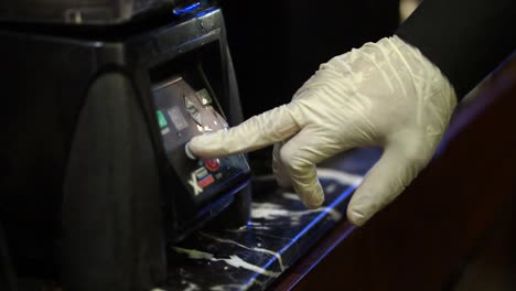 Latex-Covered-Hand-Pressing-Button-On-Blender