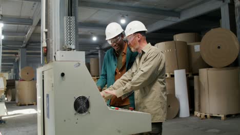 factory workers operating a machine