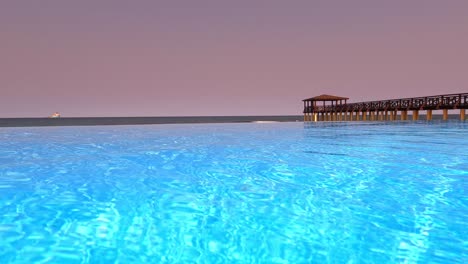 Low-view-from-a-infinity-pool-from-a-luxury-hotel-with-the-pontoon-in-background-at-São-Tomé,Africa