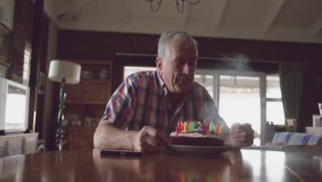 senior man with a birthday cake at home