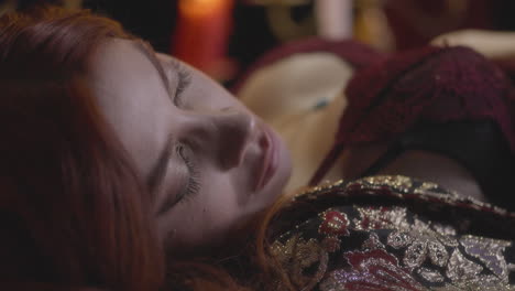 vampire elegance: sleeping girl in a red gown