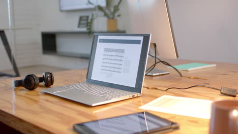 a modern business laptop open on a desk at an office, with copy space