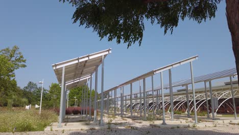 panning view over the huge field of solar panels installed at a sports center