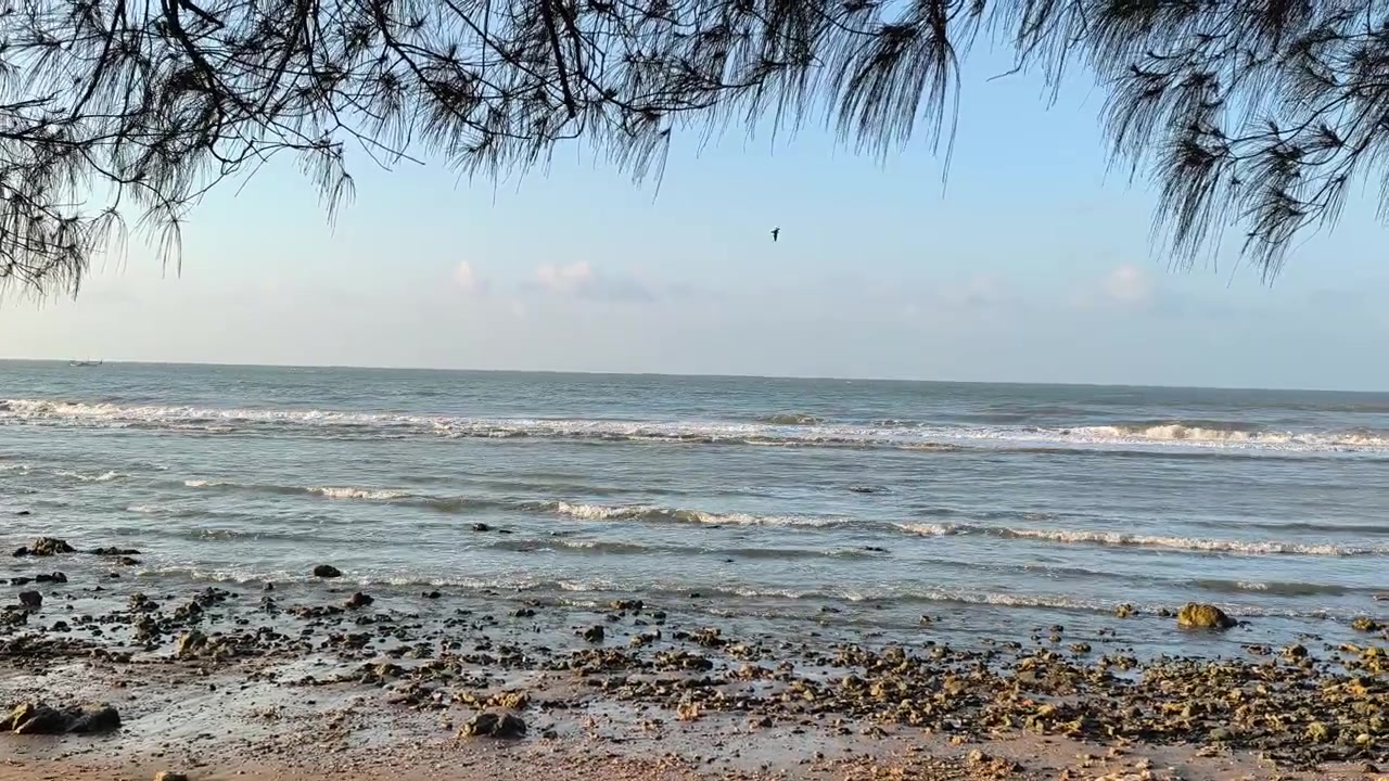Calm Ocean Waves Gently Rolling onto a Rocky Beach