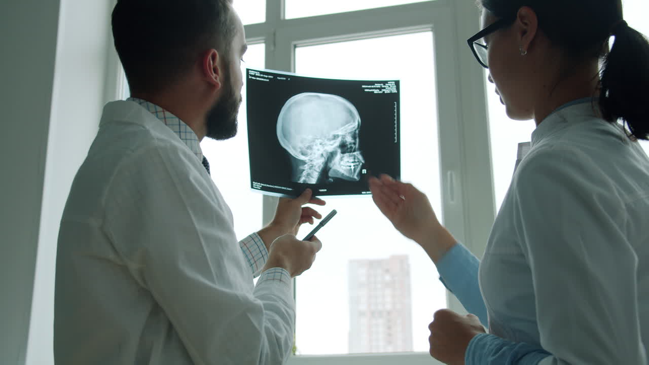 Doctors reviewing a skull X-ray