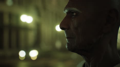 old asian man in big city at night