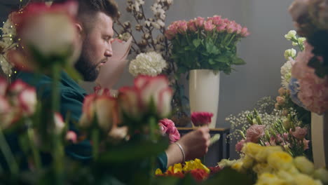 florist collects bouquet and looks at camera