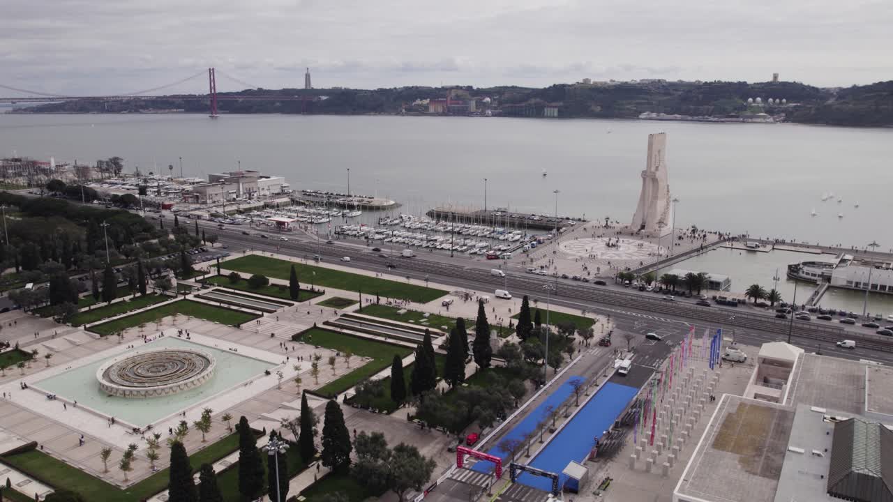 Orbiting shot of Tagus River and Lisbon landmarks, Padr&atilde;o dos Descobrimentos, gardens and 25th April Bridge