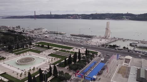 orbiting shot of tagus river and lisbon landmarks, padrão dos descobrimentos, gardens and 25th april bridge