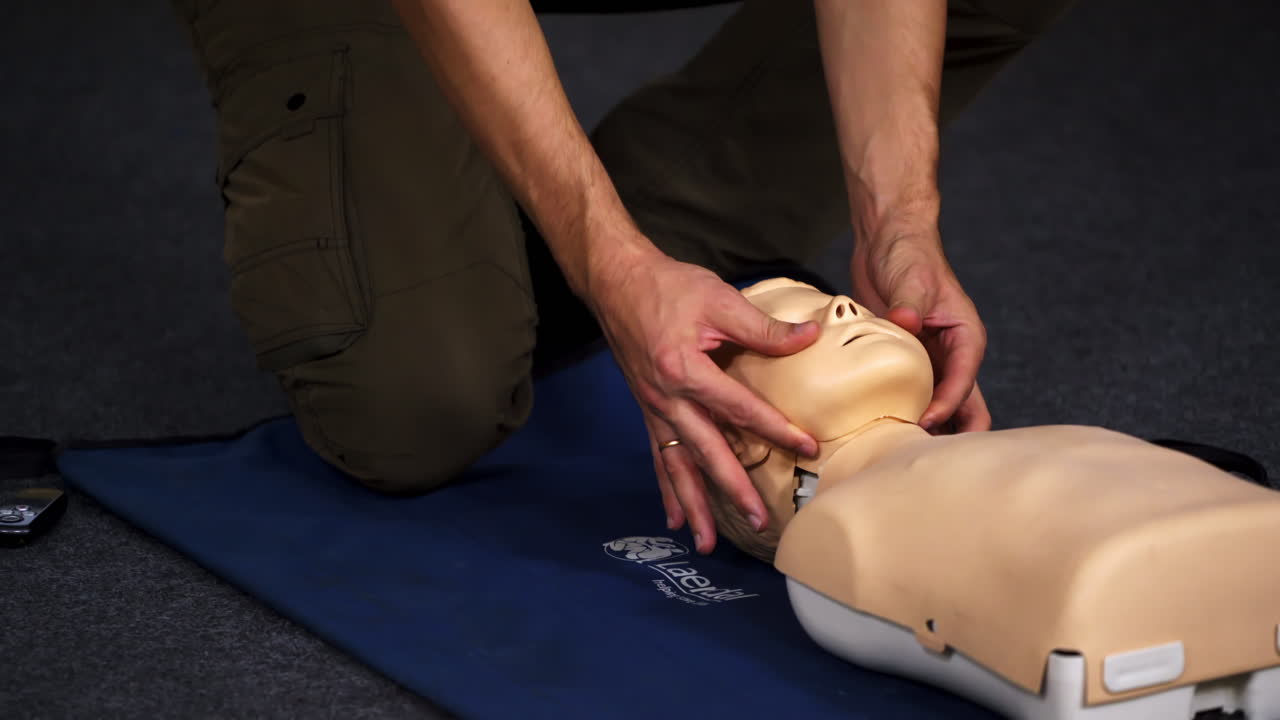 Experienced doctor shows methods of health treatment on medical dummy. Selective focus from the side.