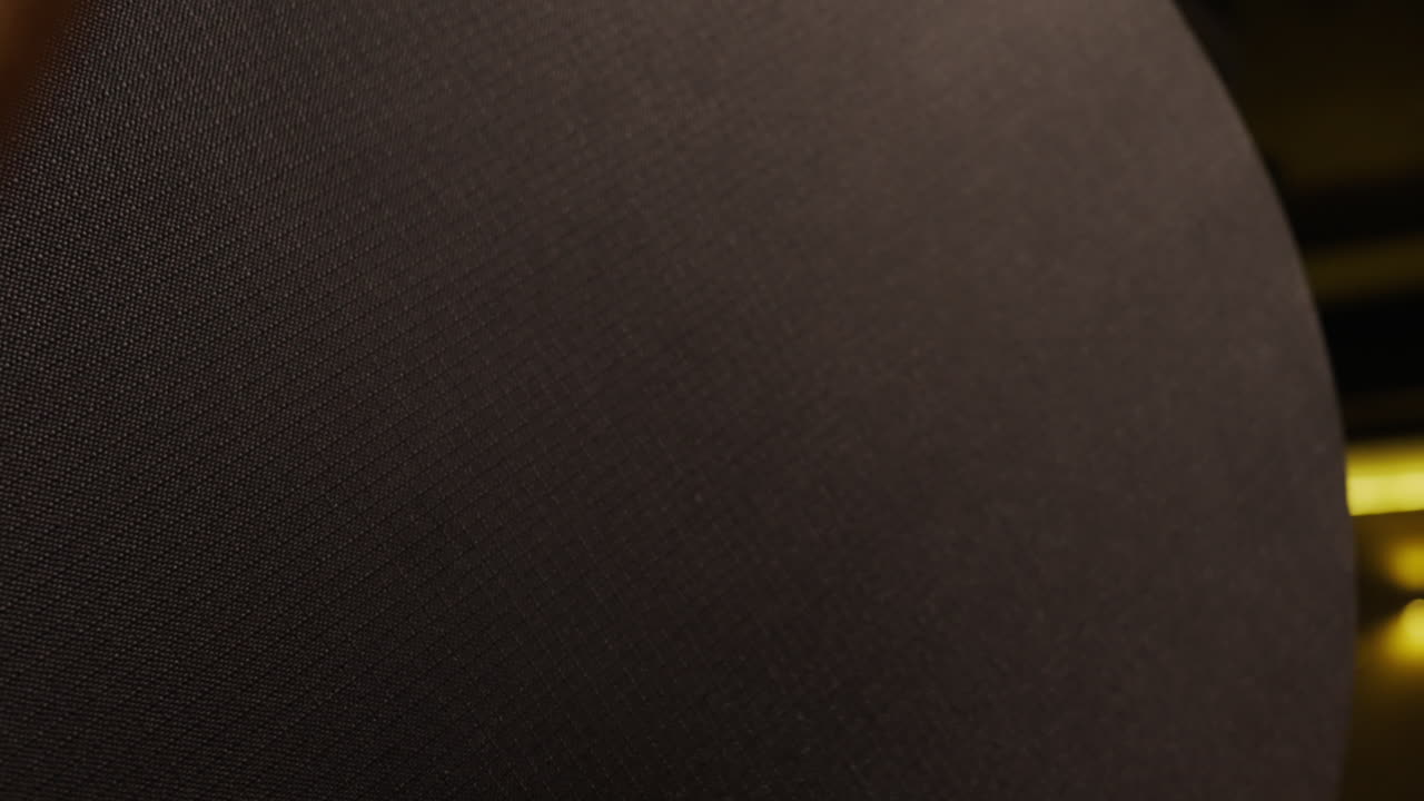 Close up of a dark drum head and drumstick