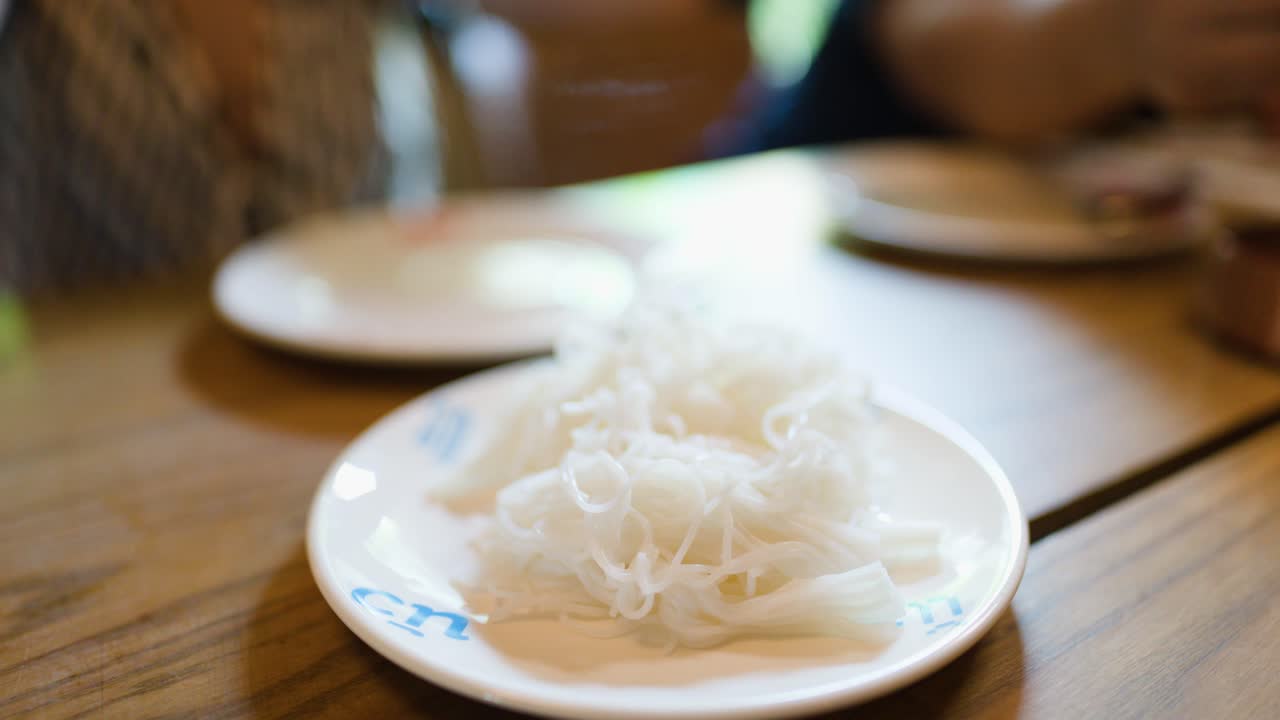 Eating rice noodles