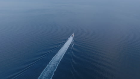 aerial footage following a speed boat that is traveling away from sorrento towards naples, italy