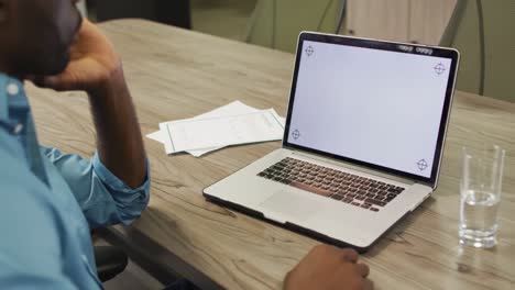 Video-Eines-Afroamerikanischen-Mannes,-Der-Einen-Laptop-Mit-Kopierplatz-Auf-Dem-Bildschirm-Benutzt