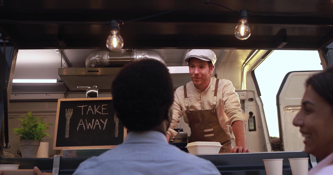 Friendly Food Truck Vendor Talking to Customers