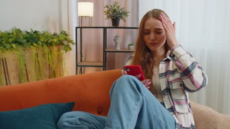 sad young woman use mobile cell phone browsing loses becoming surprised sudden bad lottery results