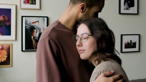 young couple hugging indoors