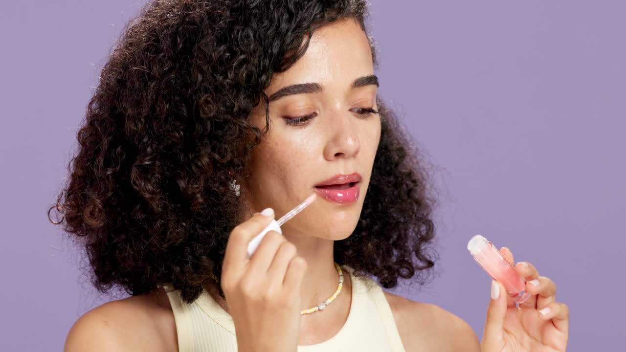 Woman applying lip gloss