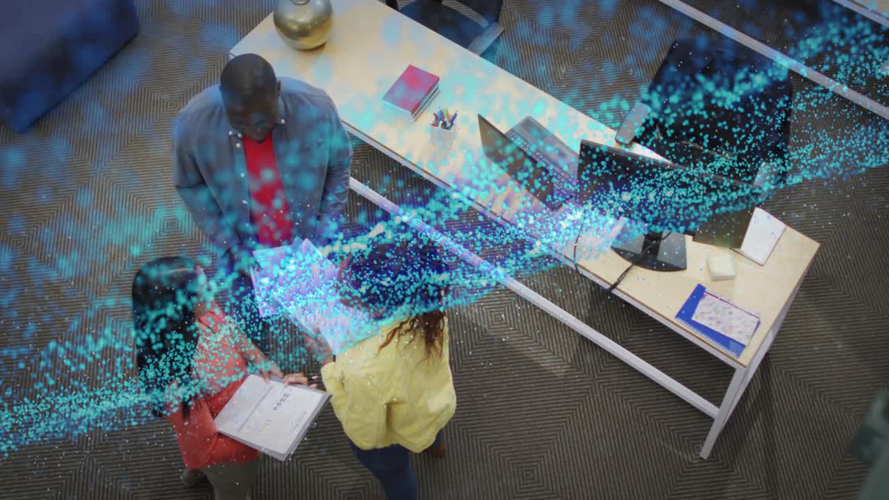 Business colleagues organizing binder and generating blue digital stream swirling across documents