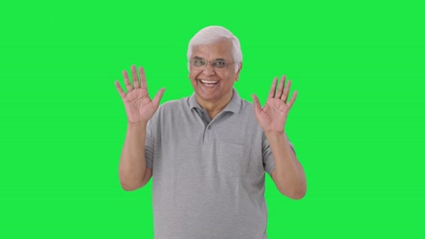 Happy-Indian-old-man-saying-hello-and-waving-Green-screen