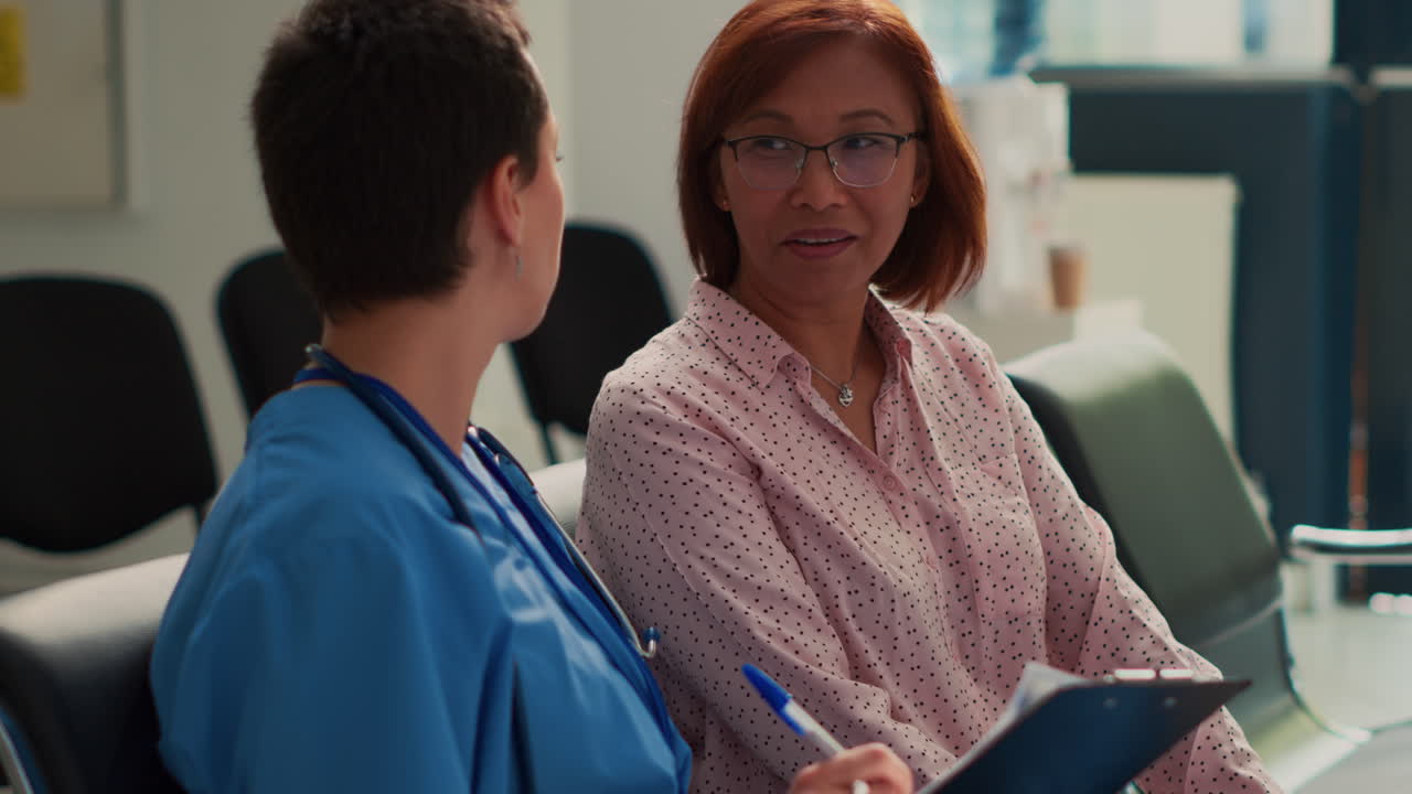 Nurse Consults with Patient in Hospital Waiting Room