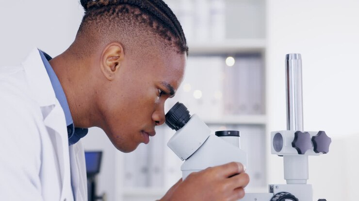 Science, microscope and medical with a doctor man
