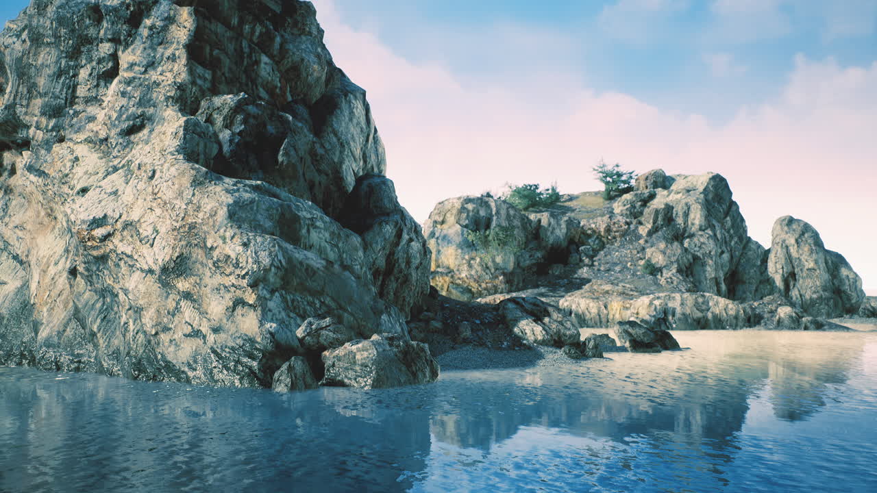 Beautiful rocky coastline reflecting in tranquil water at dawn