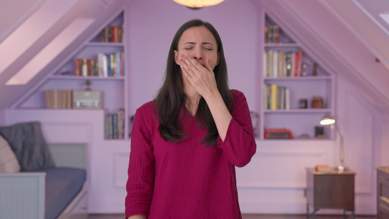 Tired and lazy Indian woman yawning and relaxing