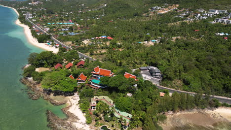 waterfront hotels at tropical bang por beach in koh samui, thailand, aerial view