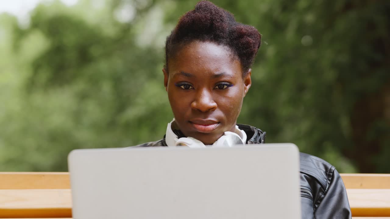 Woman working on a laptop outdoors