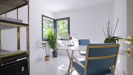 Minimalist-study-with-a-shelf-table-and-two-blue-armchairs