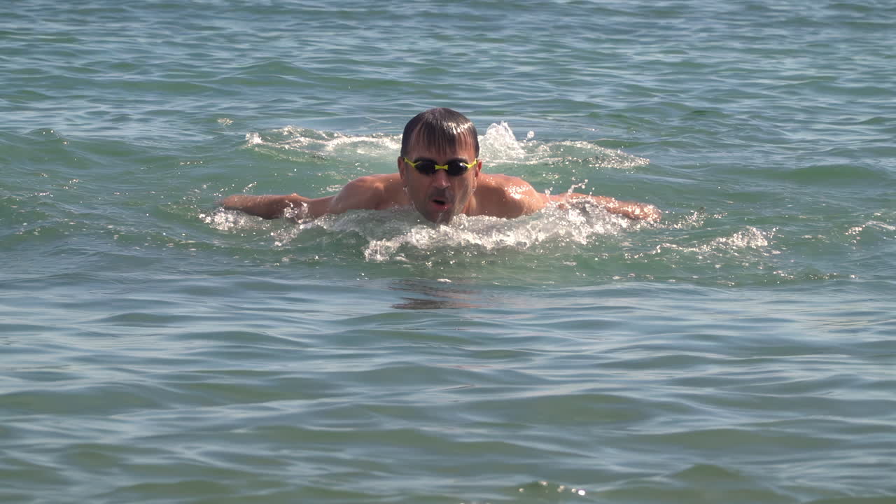 Man swimming in the sea on a sunny day
