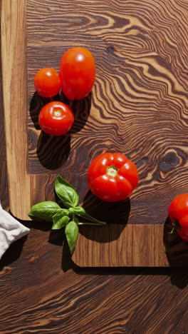 tomatoes and basil on a wooden cutting board