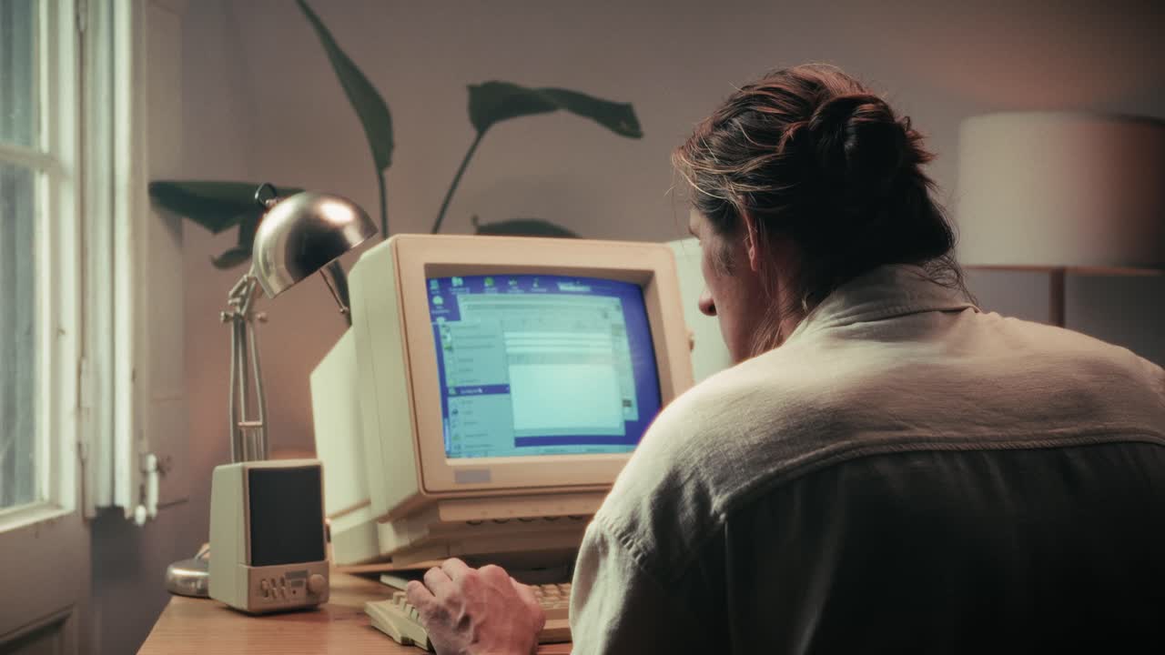 Man working and gaming on retro computer PC, IT engineer with vintage computer at home, using old fashion technology, close up of retro setup.