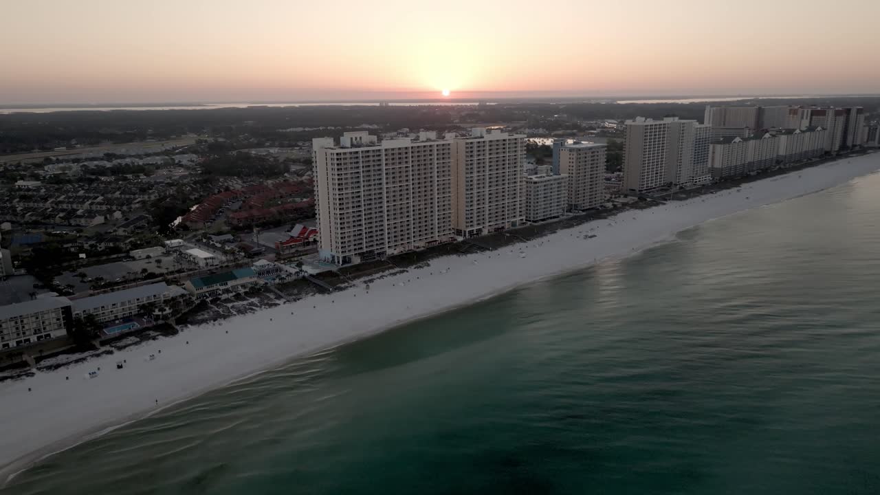 Sunrise in Panama City Beach, Florida showing hotels and Gulf of America with drone video moving in a medium circle.