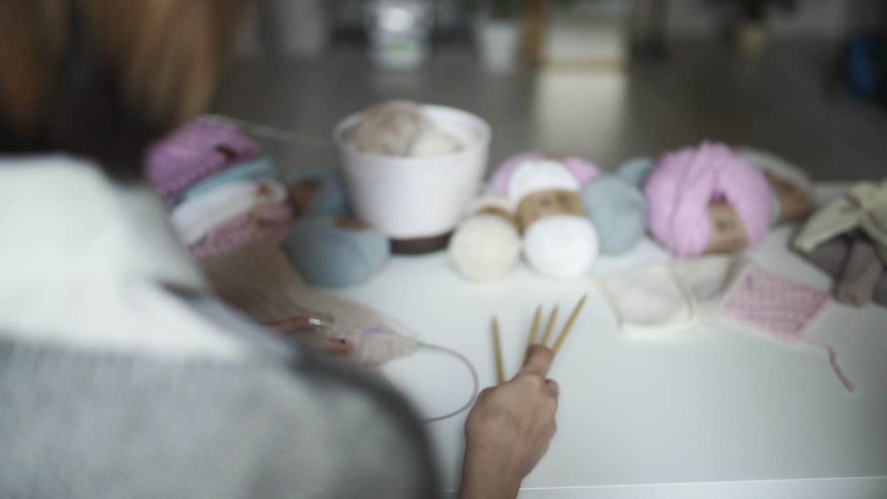 테이블에서 바느질 액세서리를 바느질하는 여성 손. 여성 취미 뜨개질 양털