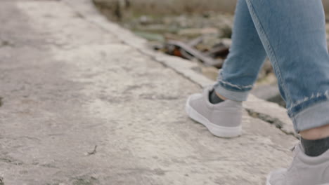 young woman walking alone on seaside lonely teenage girl depression concept