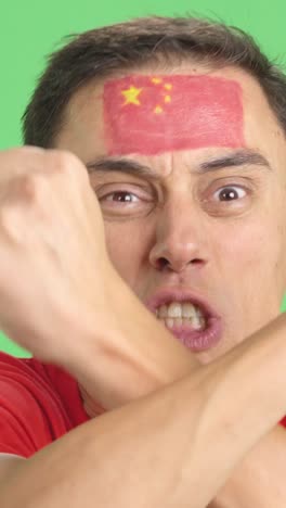 man with chinese national flag upset with a football referee