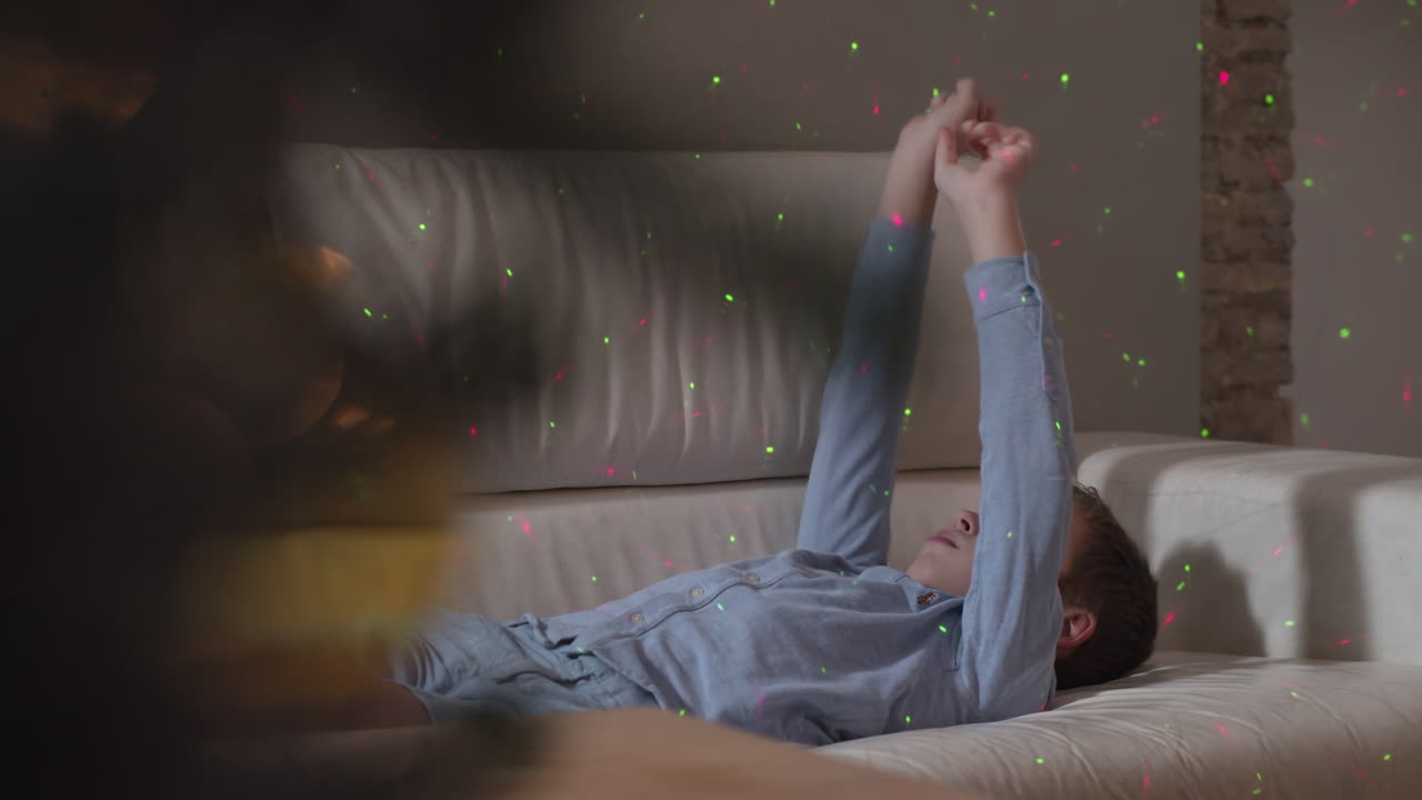 점들을 잡으려고 x-마스 불빛으로 놀고 있는 소년